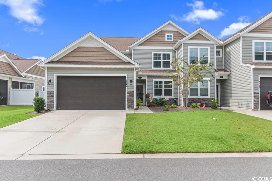 Craftsman house with a front yard and a garage