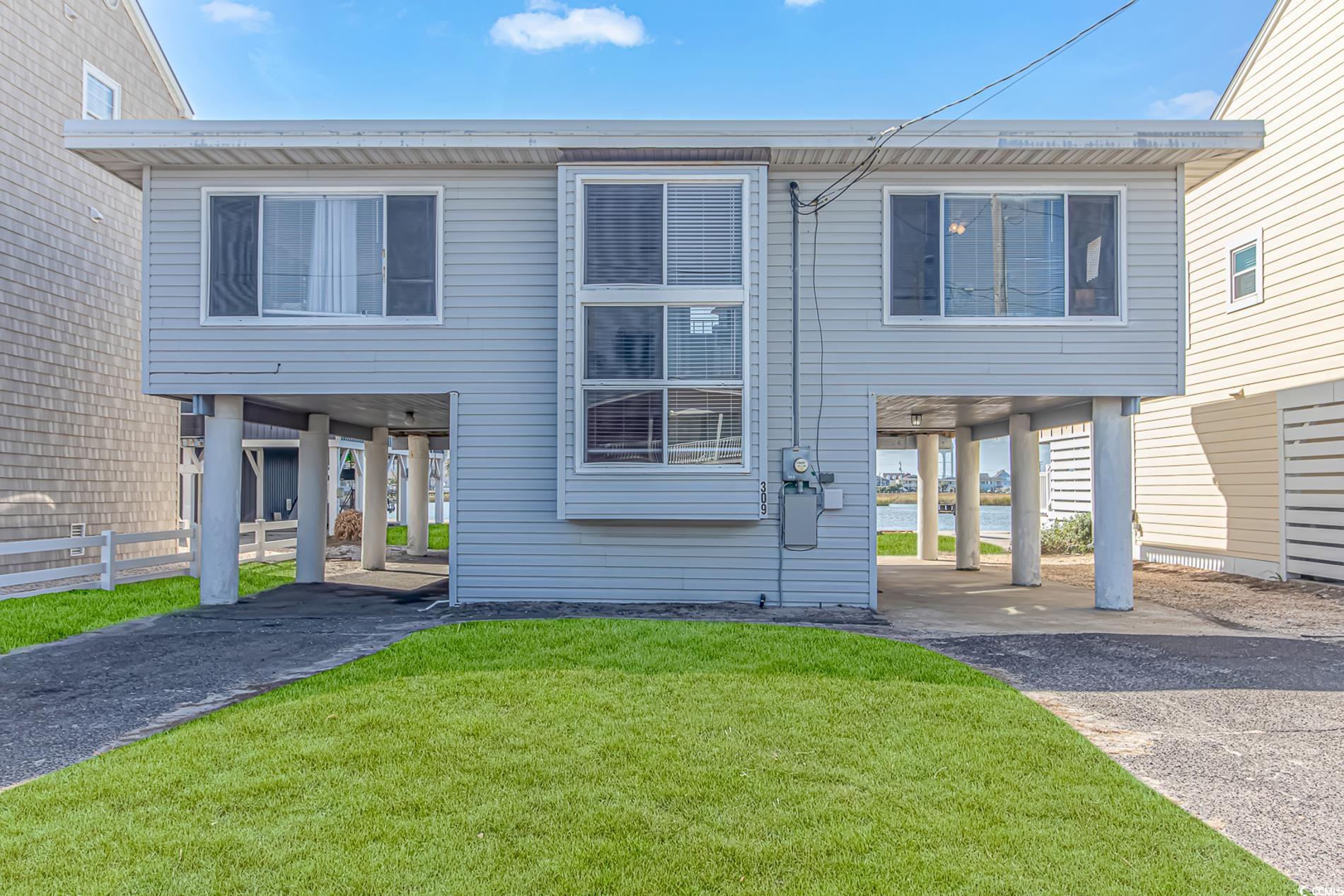 View of front of property featuring a front yard a