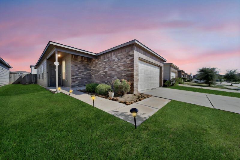 a front view of house with yard and green space