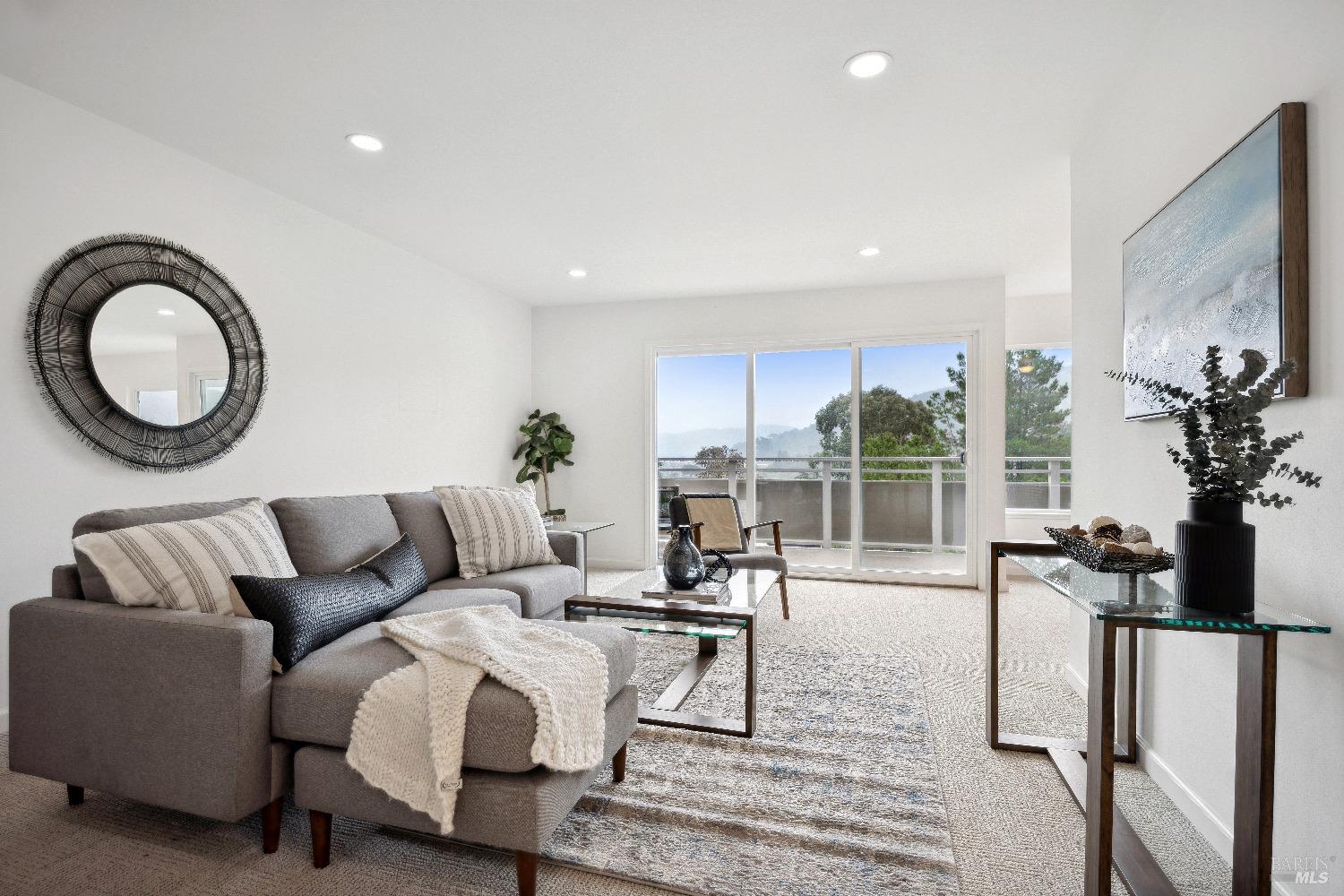 a living room with furniture and a floor to ceiling window