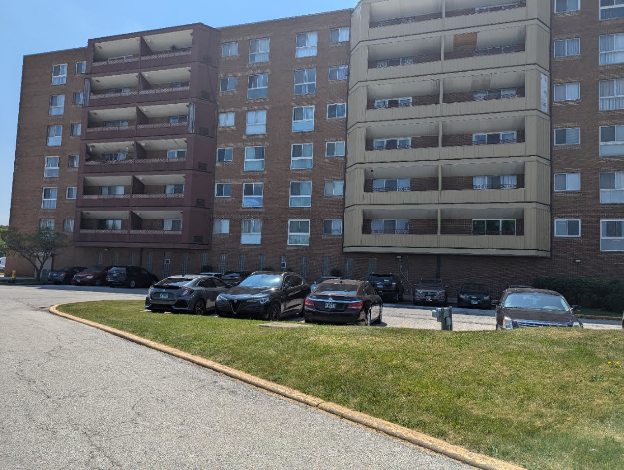 a front view of building with outdoor seating and yard