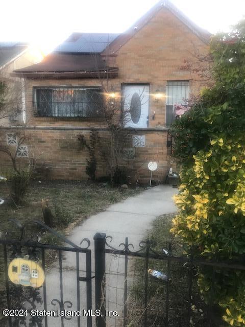 a view of a brick house next to a yard