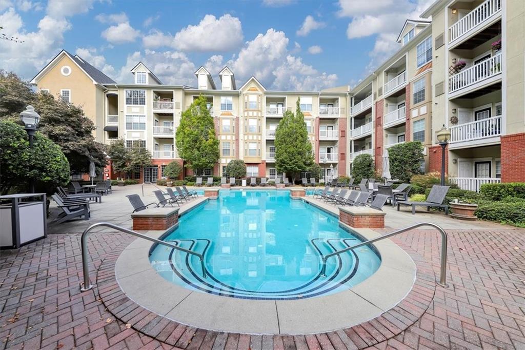 a view of a swimming pool with outdoor seating