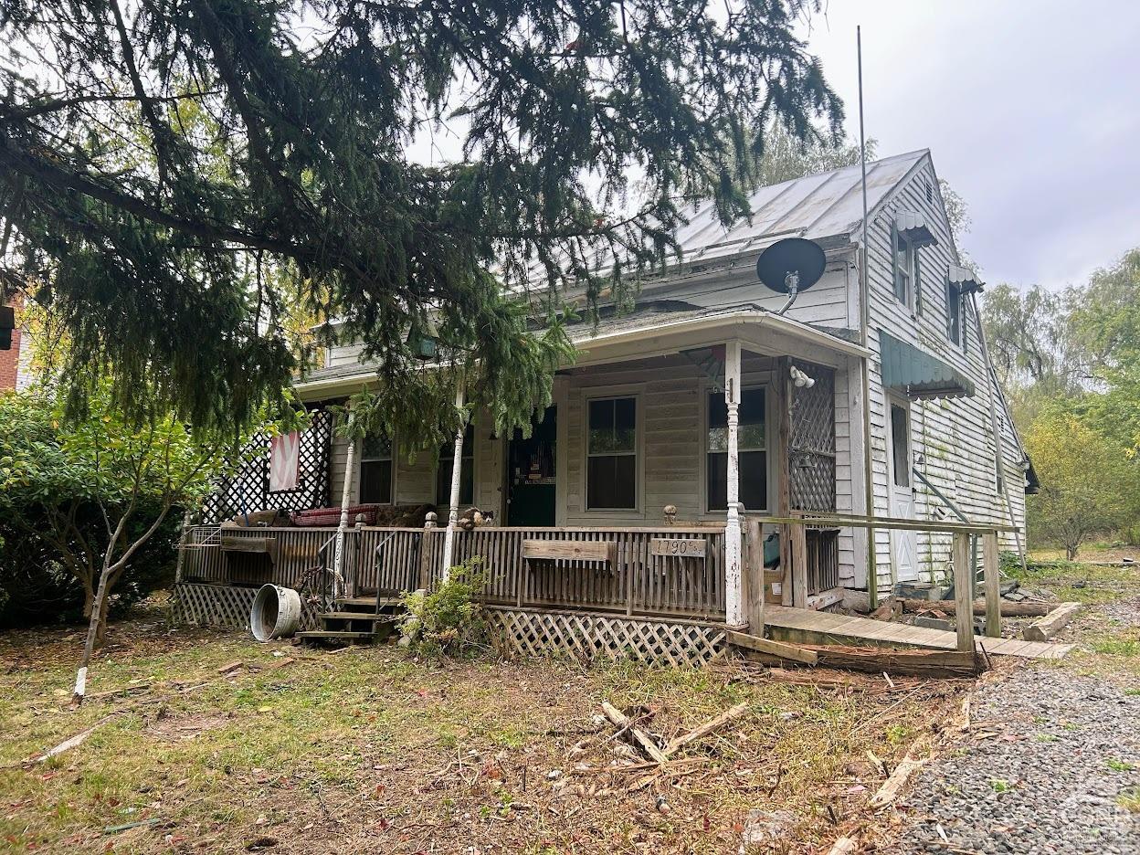 front view of a house with a large window and furniture