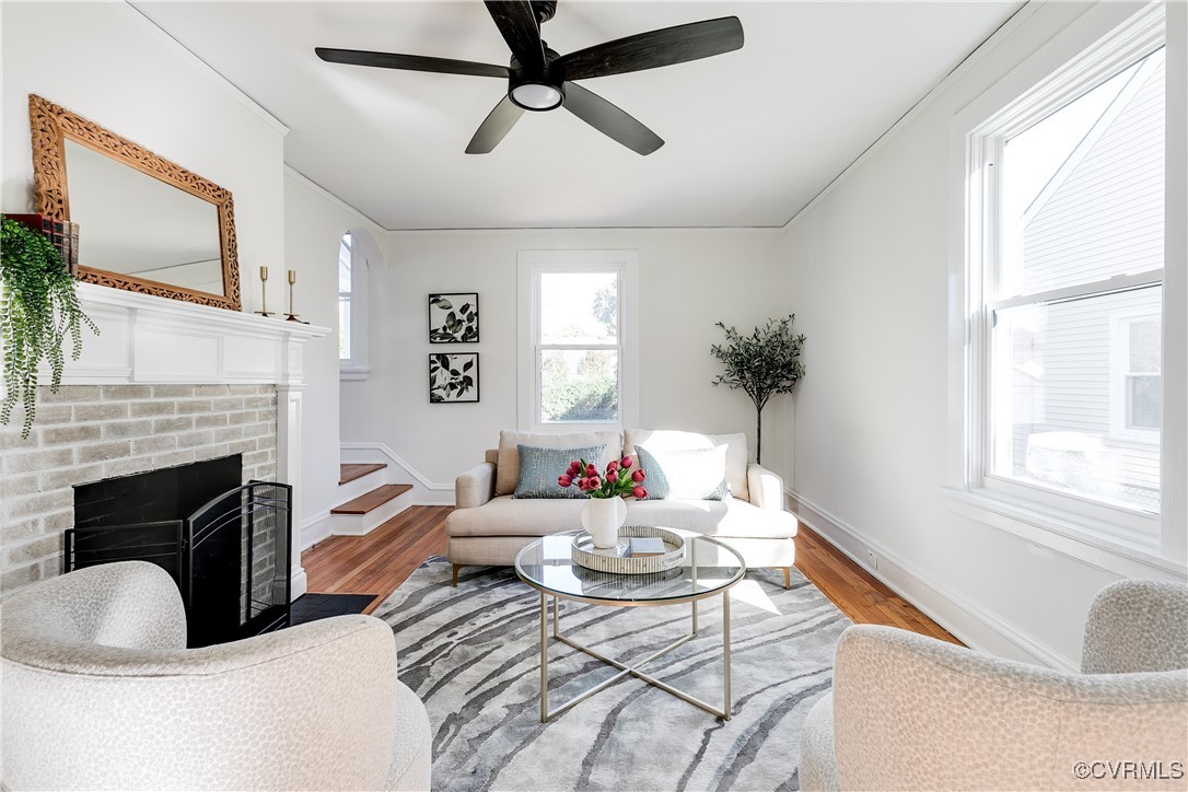 a living room with furniture fireplace and a window