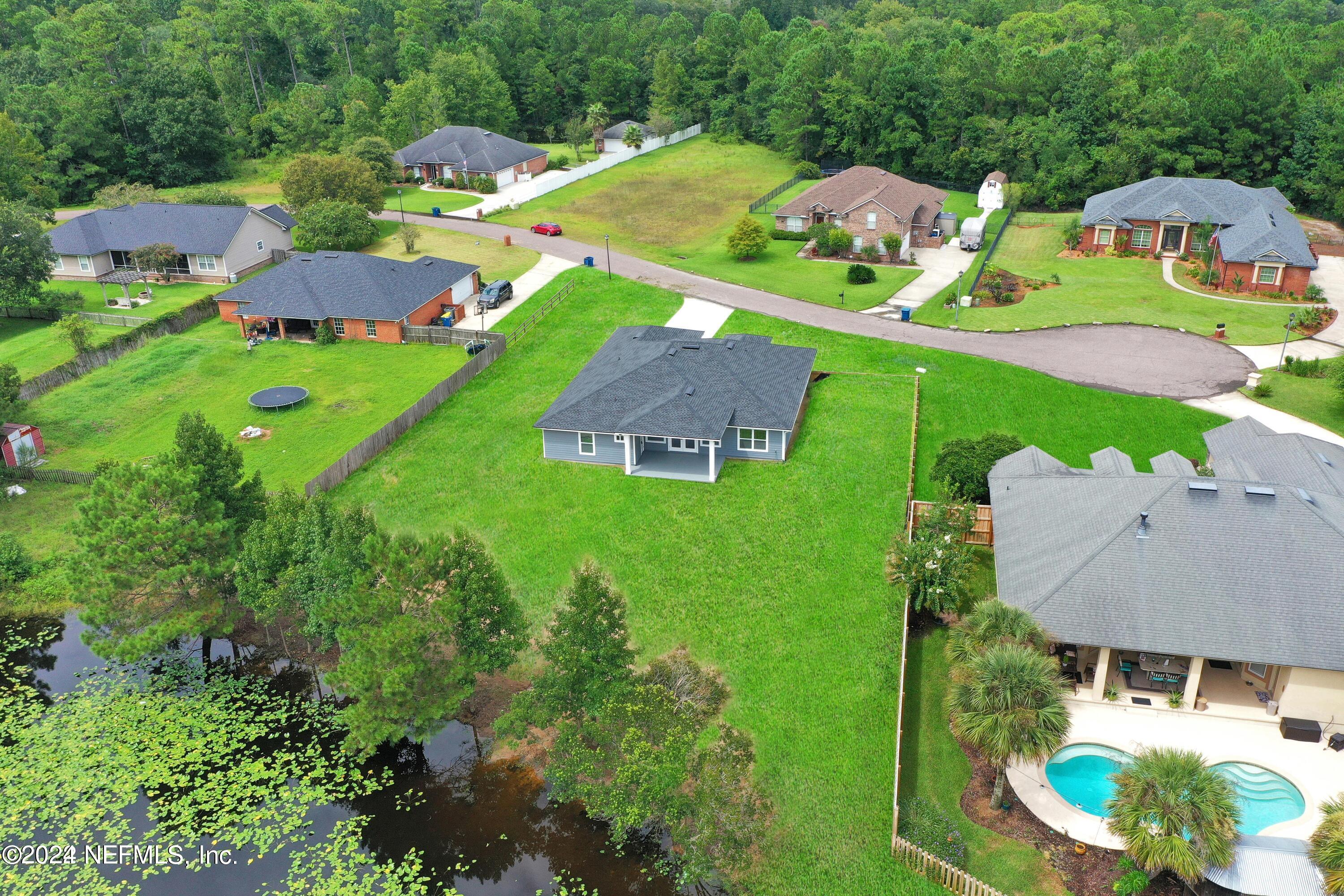 an aerial view of house with yard