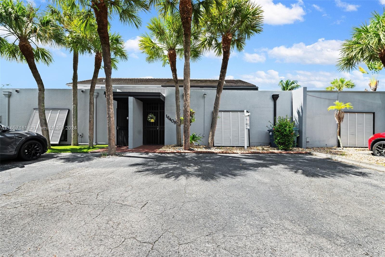 a view of a house with backyard space and palm tree