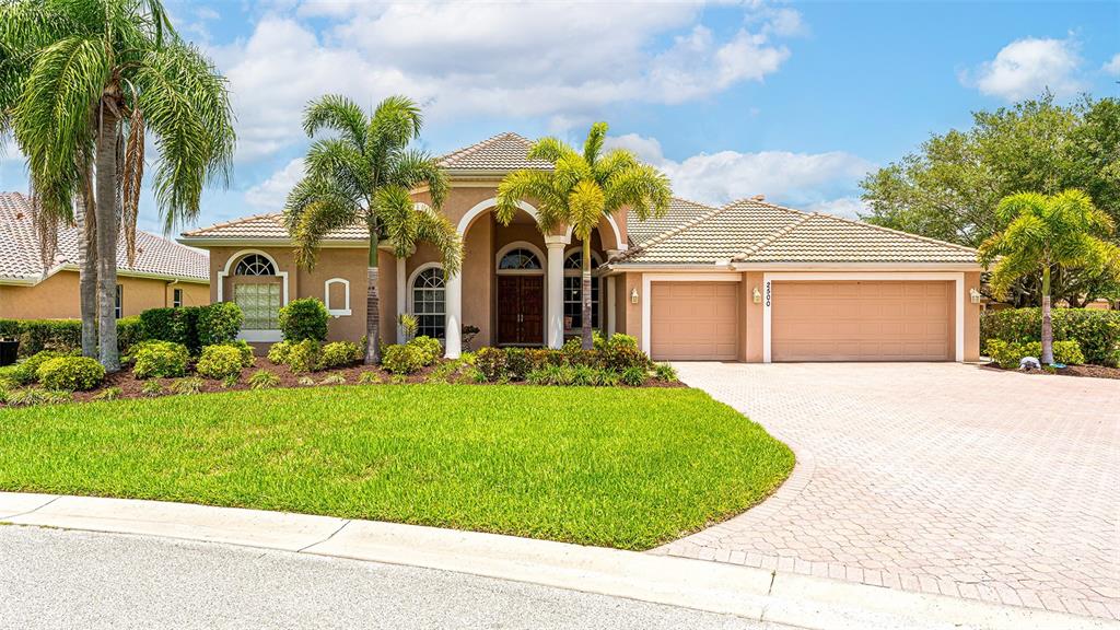 Impressive curb appeal with portico entry and paver driveway!