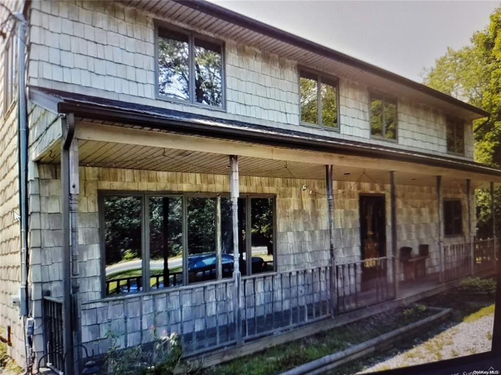 an outdoor view of shop with window and porch