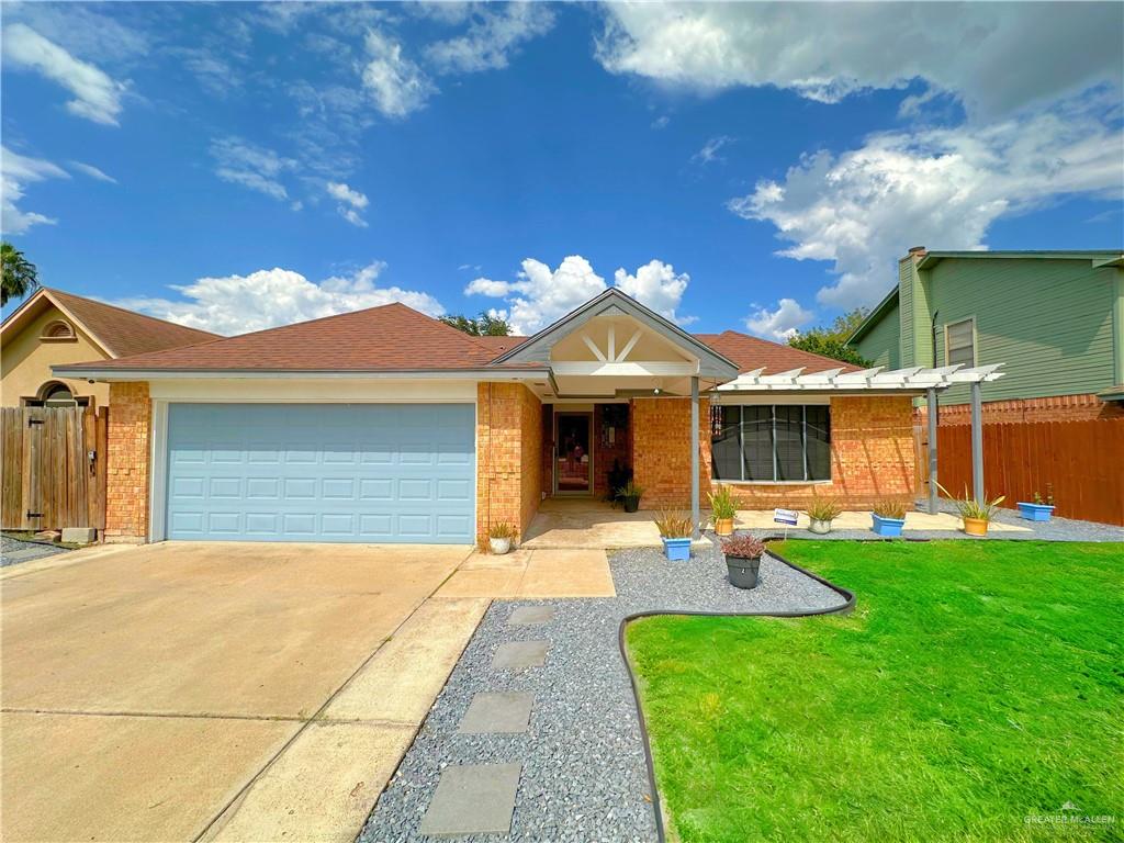 View of front of property with a front yard and a garage