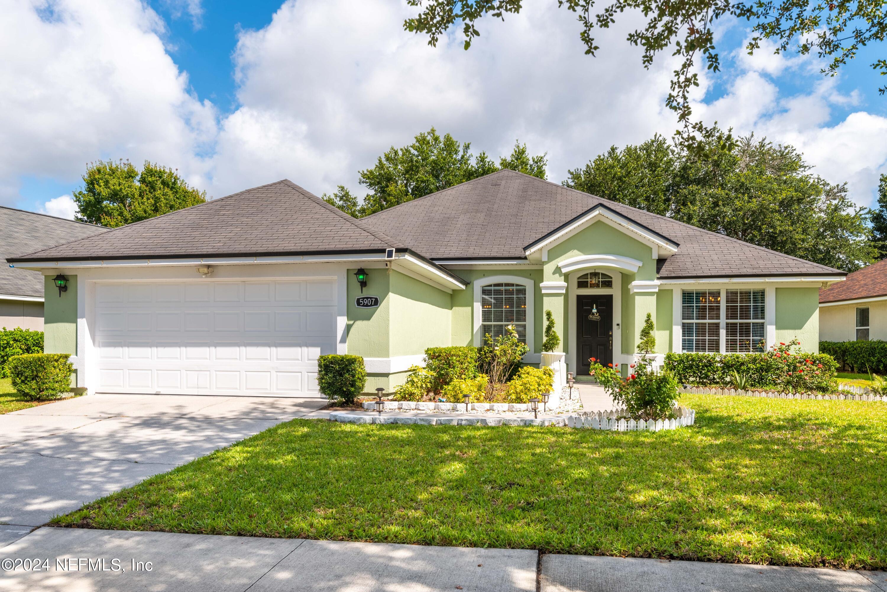 a front view of house with yard and green space