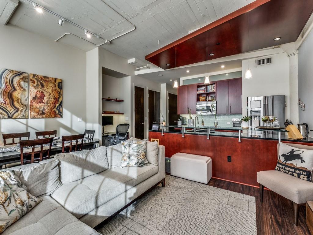 a living room with furniture and a kitchen view