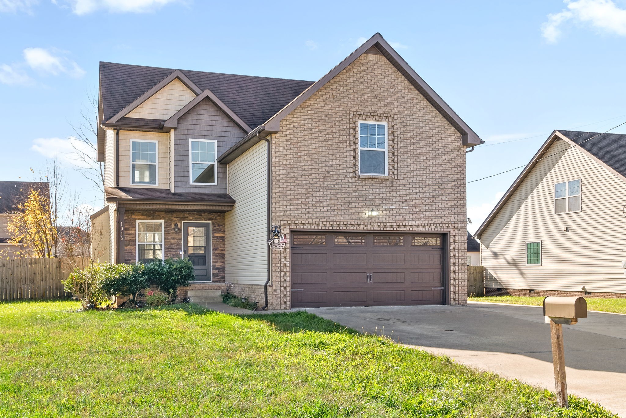 a front view of a house with a yard and garage