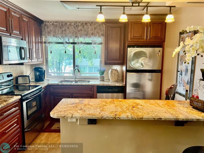 a kitchen with a stove a sink and a refrigerator