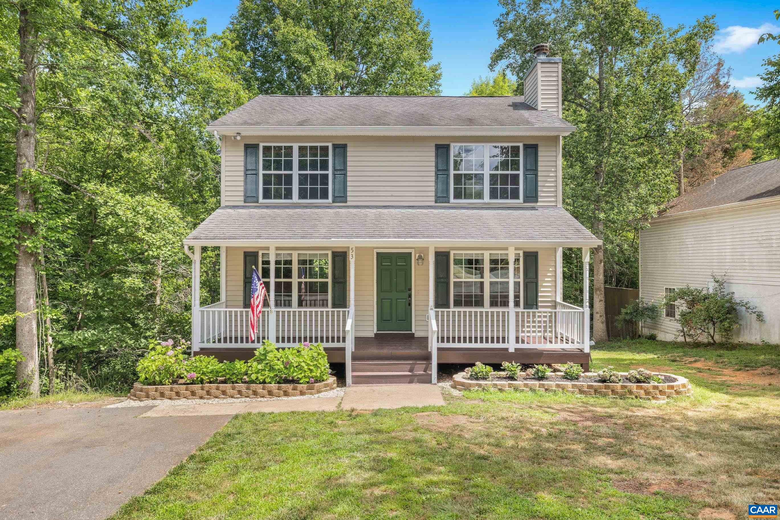 a front view of a house with a yard and porch