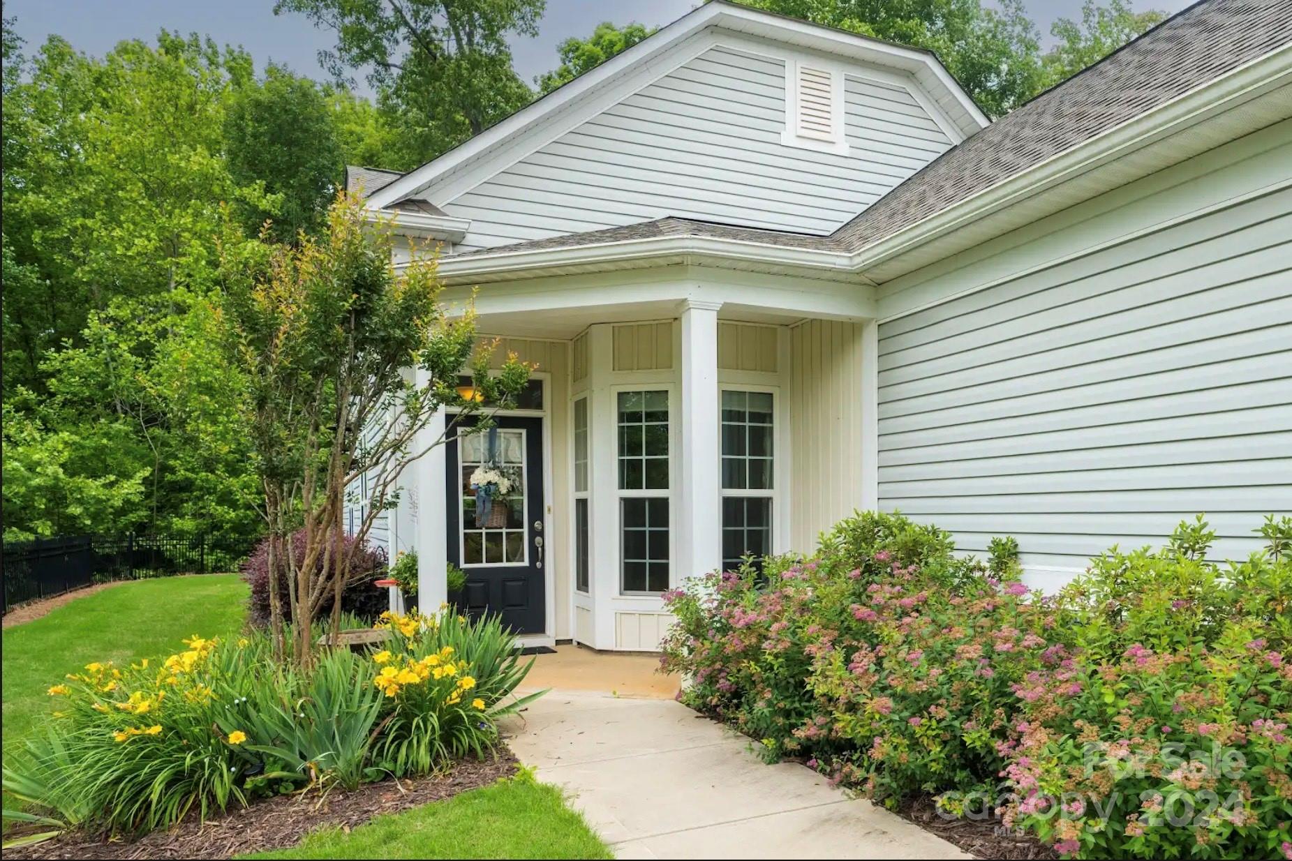 a front view of a house with a garden