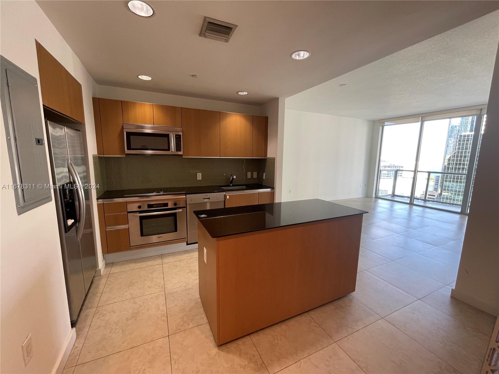 a kitchen with stainless steel appliances a stove a refrigerator and a sink