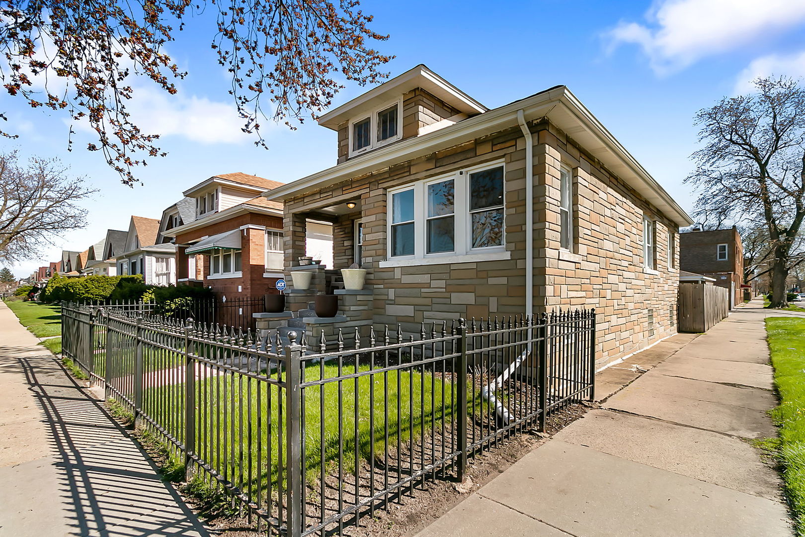 a front view of a house with a wooden fence