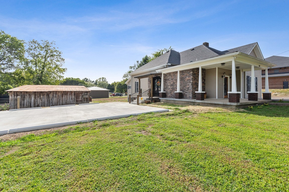 a front view of a house with a yard table and chairs