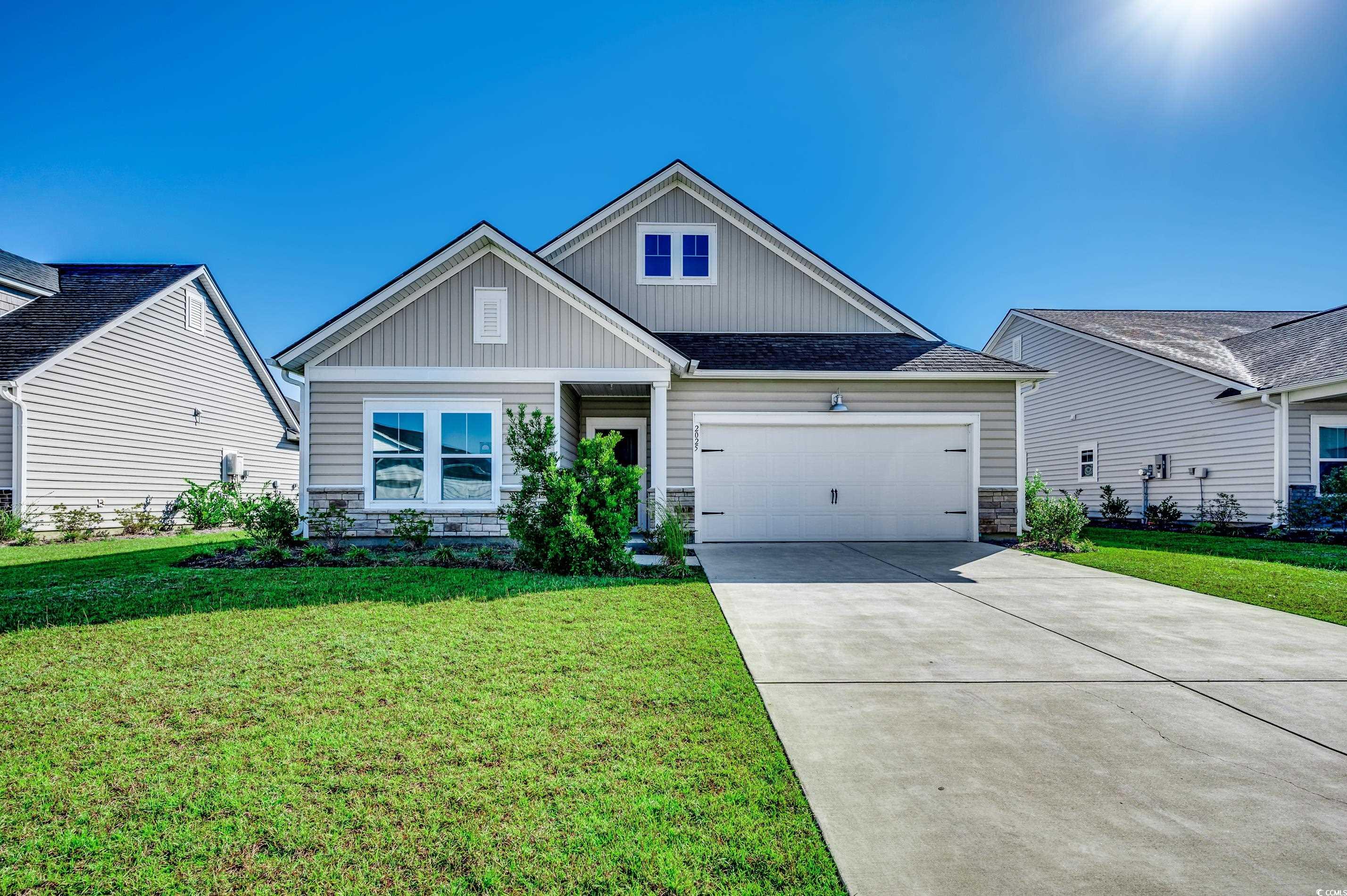 View of front of house featuring a garage and a fr