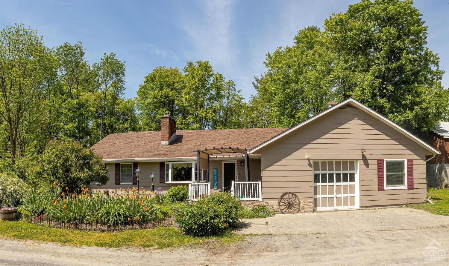 a front view of a house with a garden