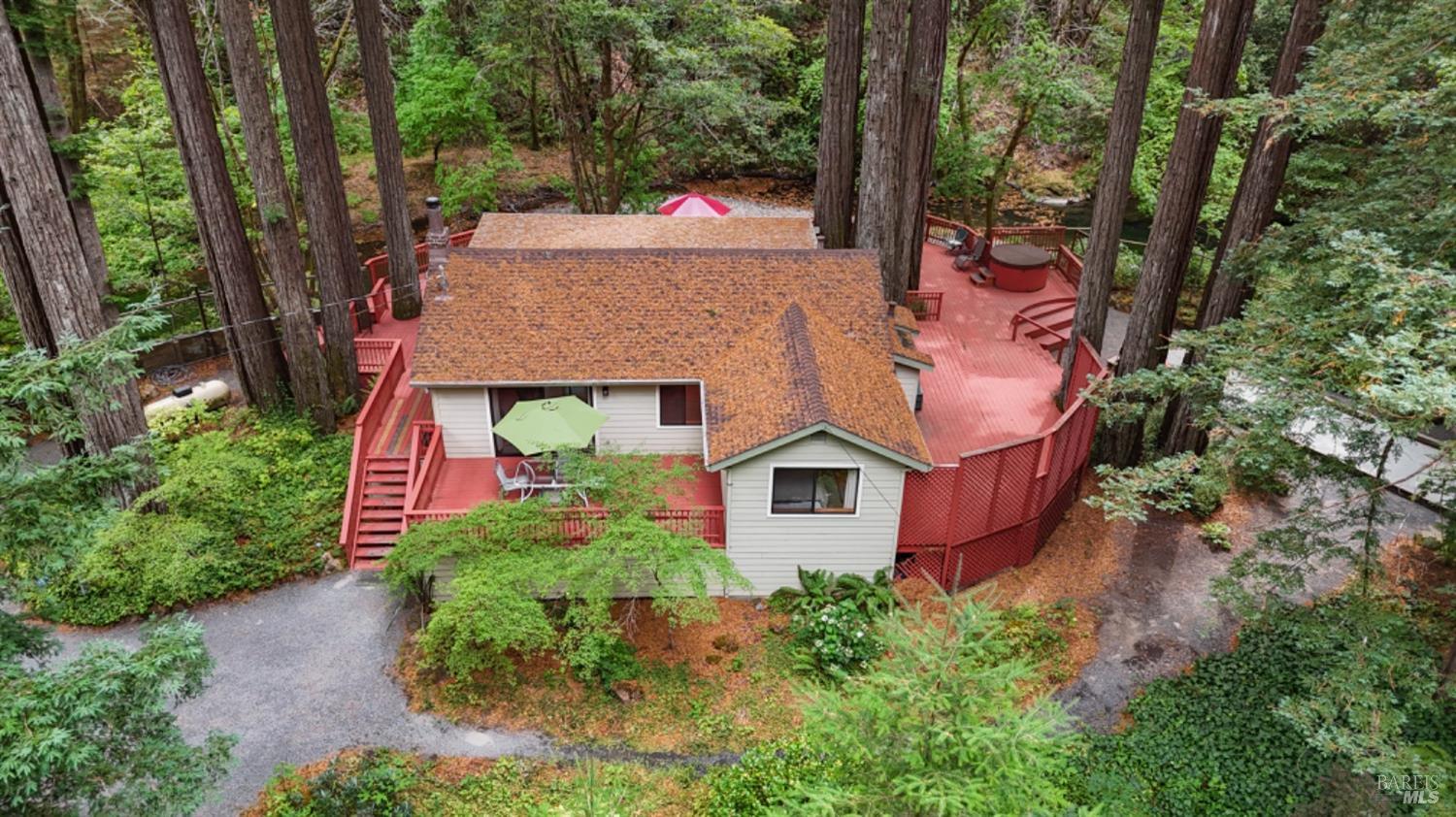 an aerial view of house with yard and swimming pool