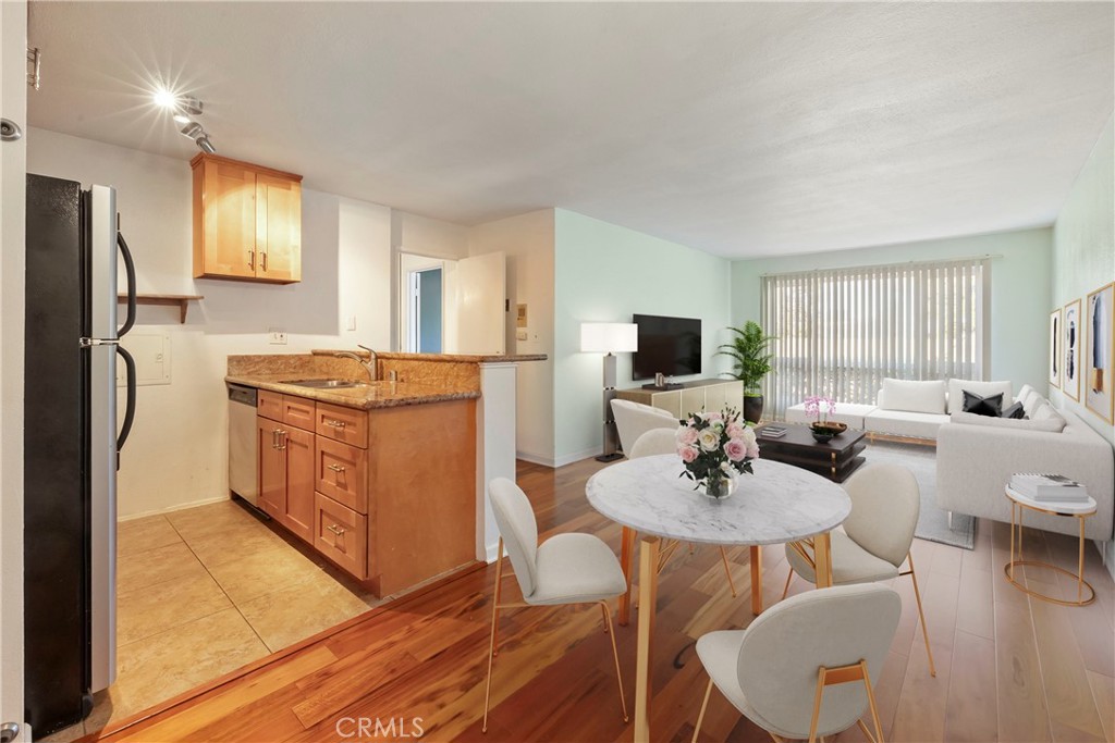 a kitchen with stainless steel appliances a dining table and chairs