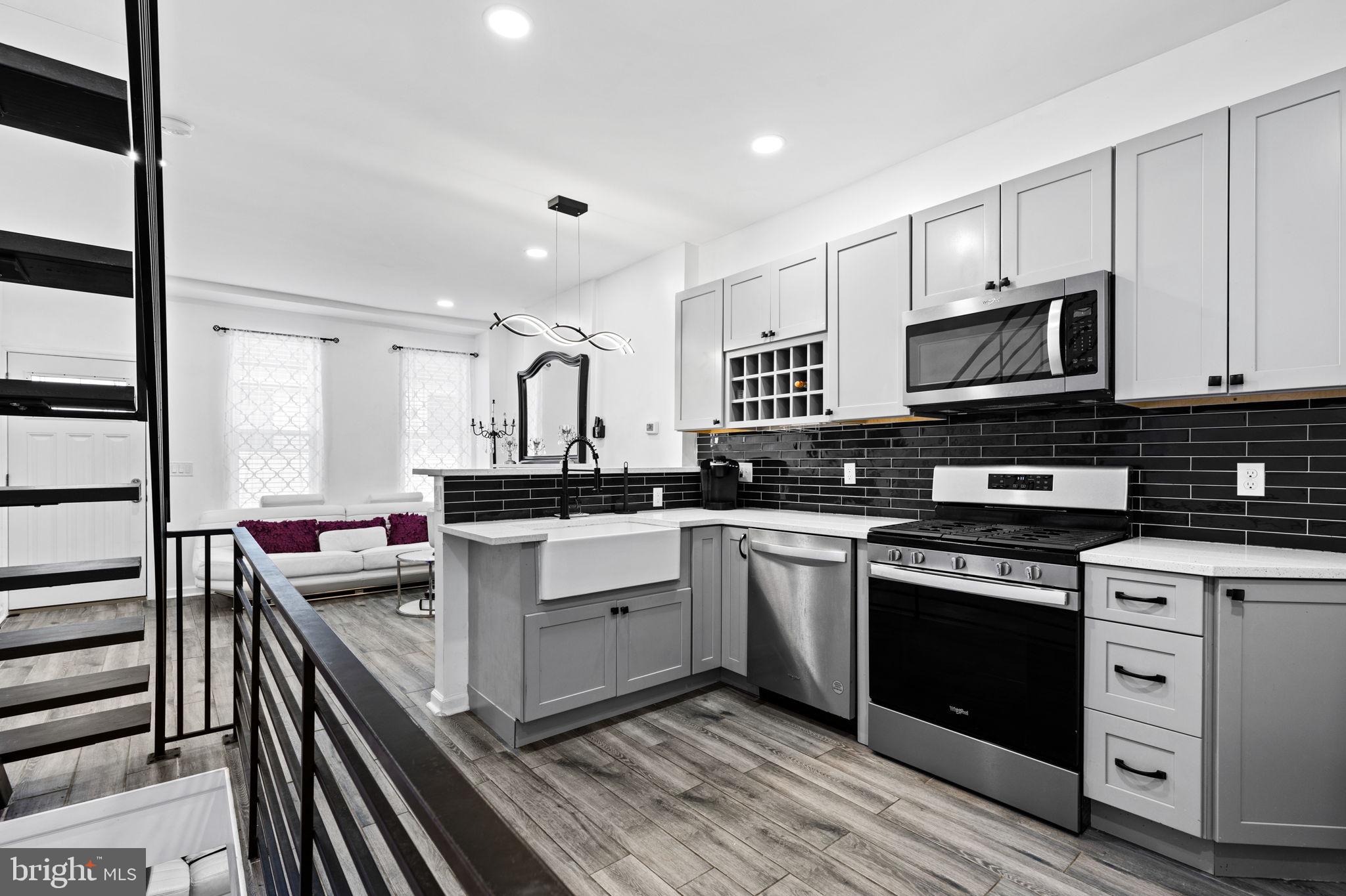 a kitchen with stainless steel appliances granite countertop a stove sink and cabinets