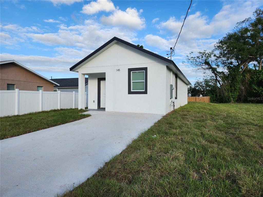 a view of a house with a yard and garage