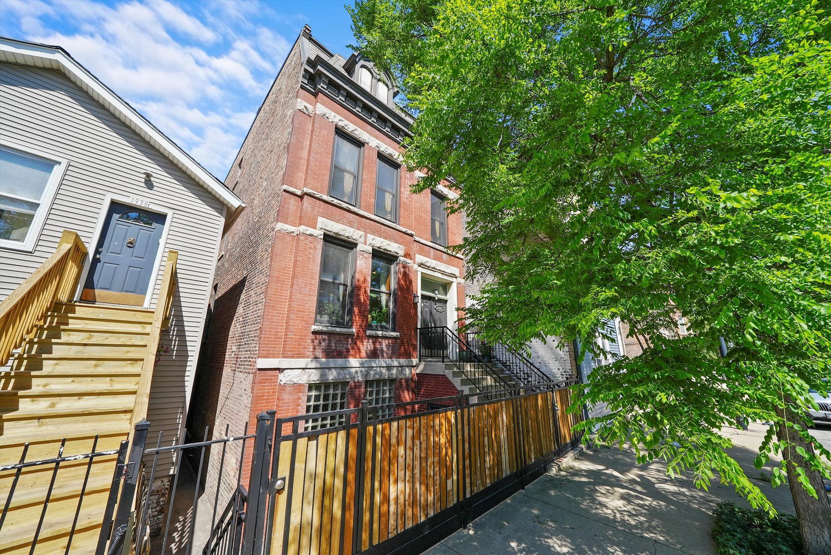 a view of a house with wooden fence