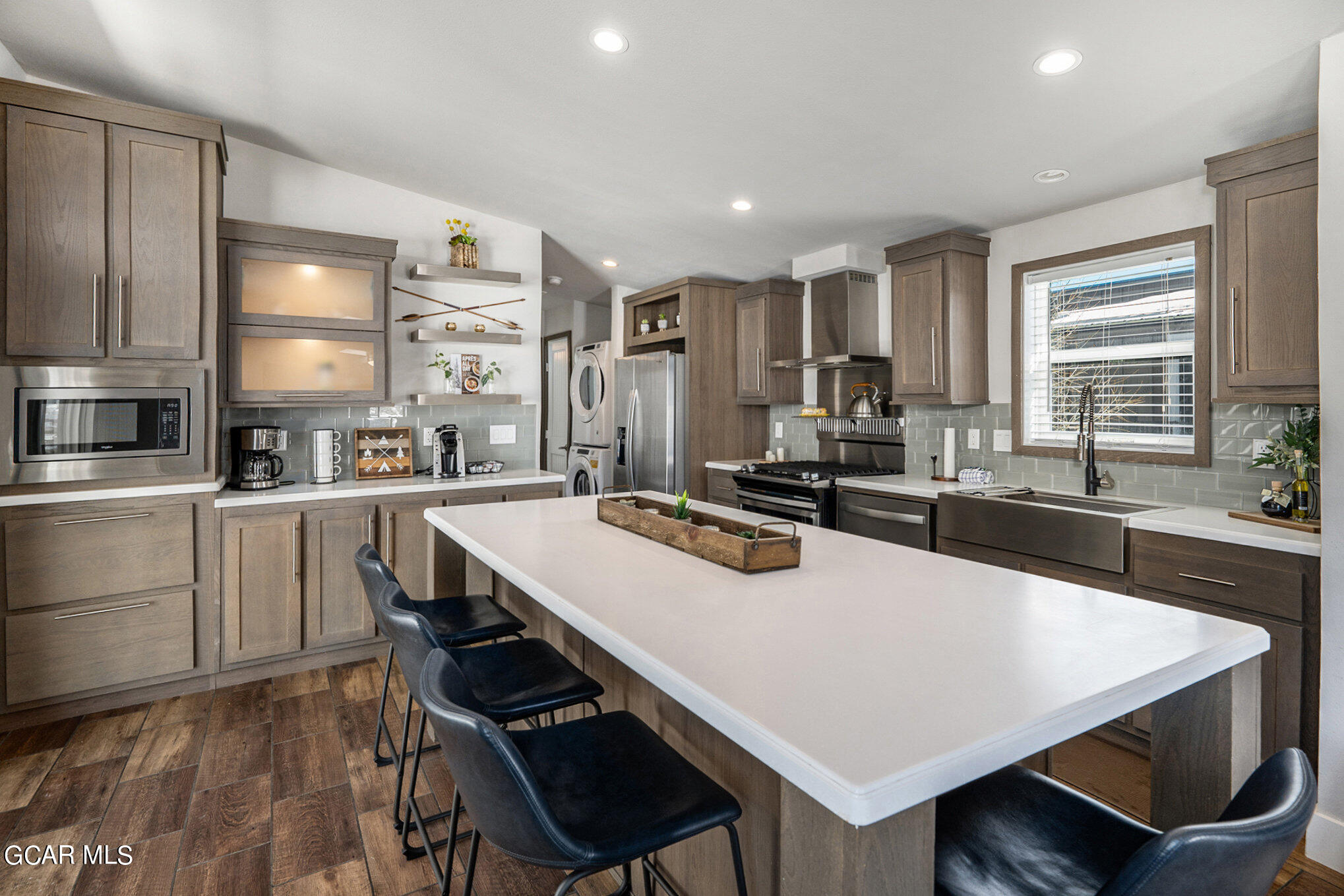 a large kitchen with a table chairs and refrigerator