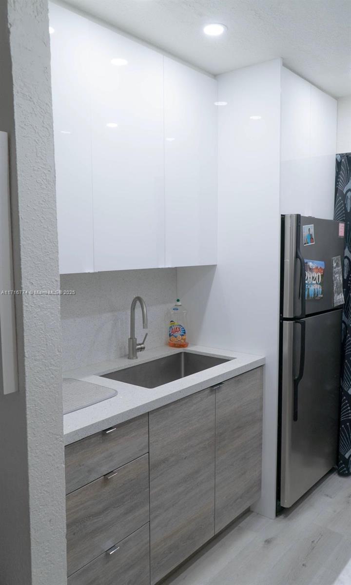 a kitchen with a sink and refrigerator