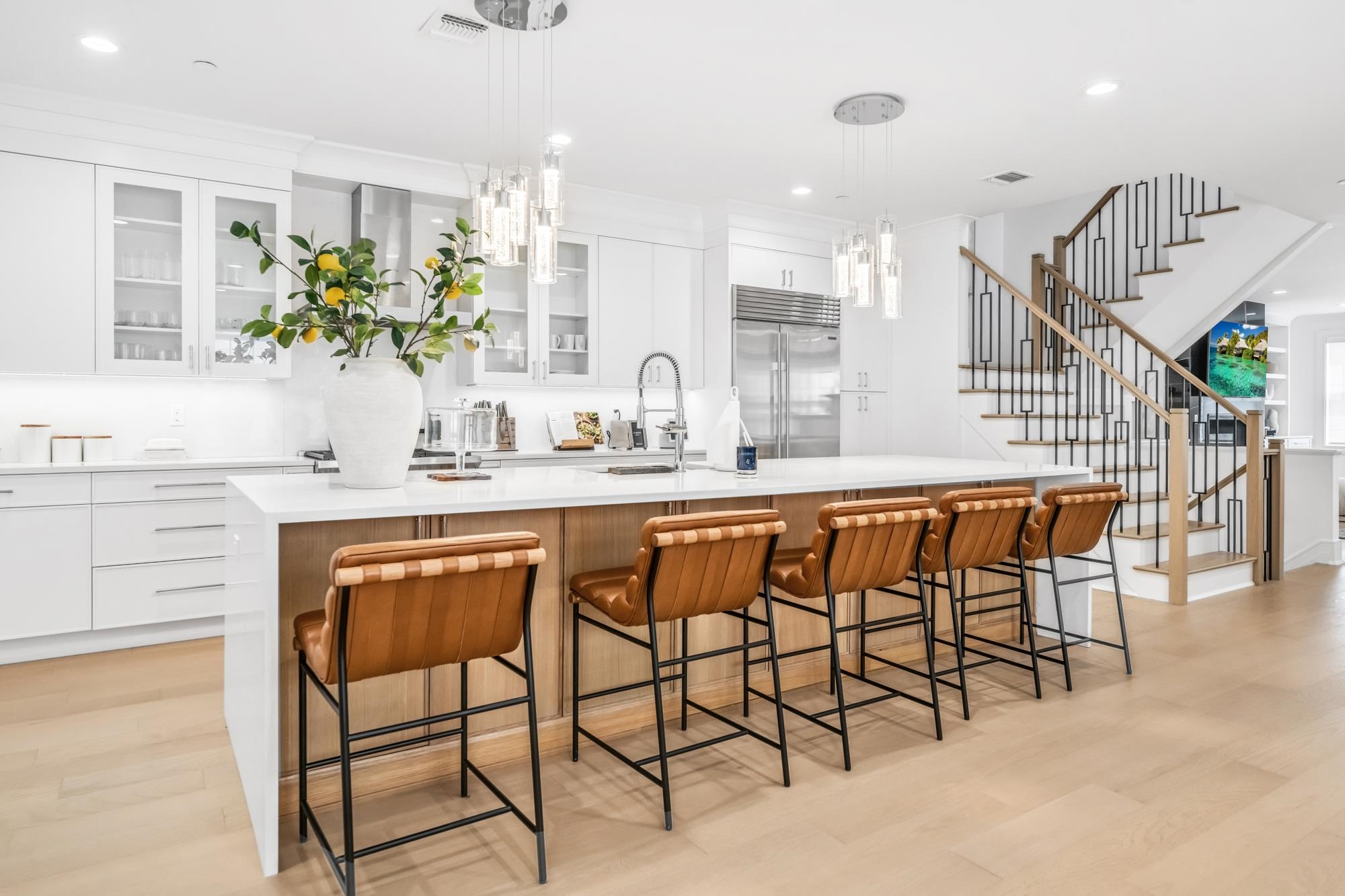 a dining hall with stainless steel appliances kitchen island granite countertop a table and chairs in it