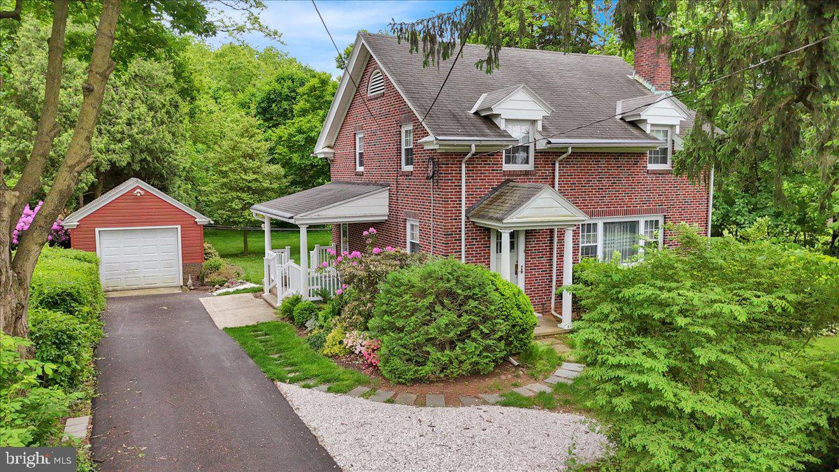 a aerial view of a house with a yard and potted plants