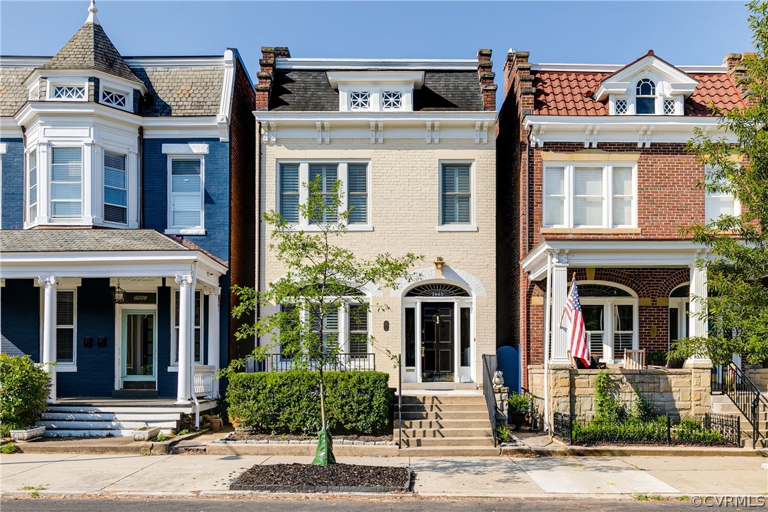 a front view of a residential houses with a yard