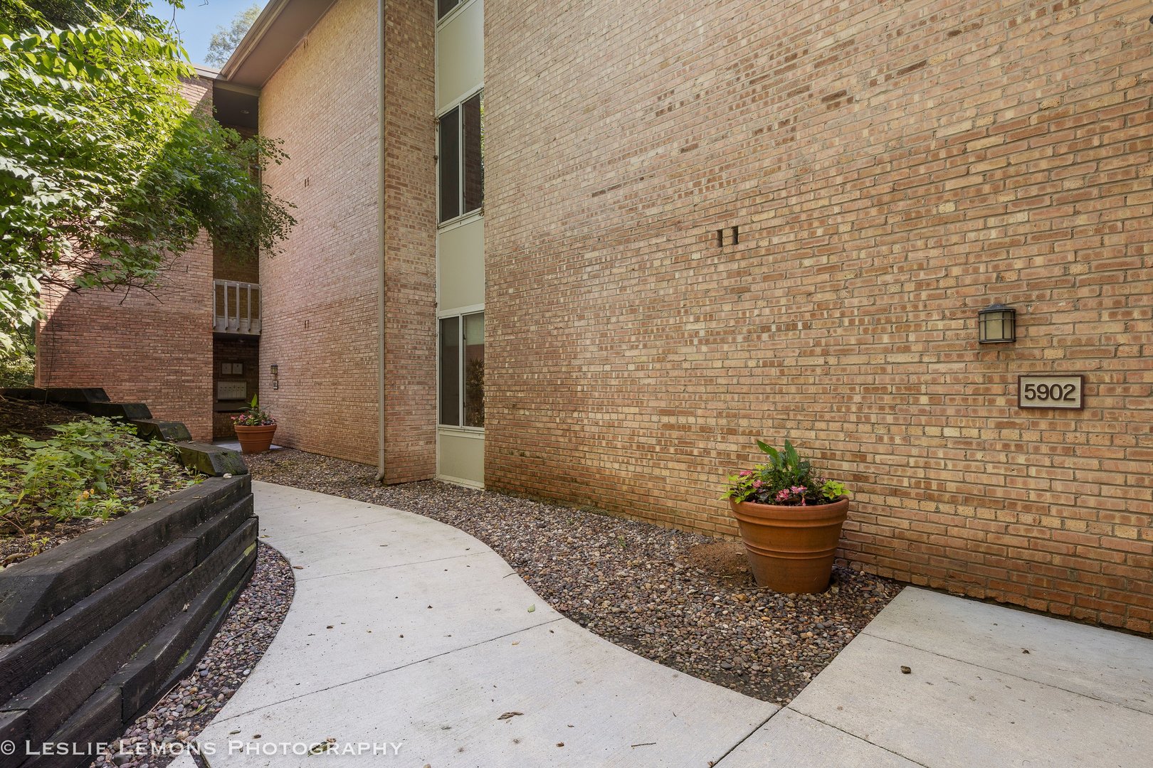 a view of a backyard of a house with potted plants