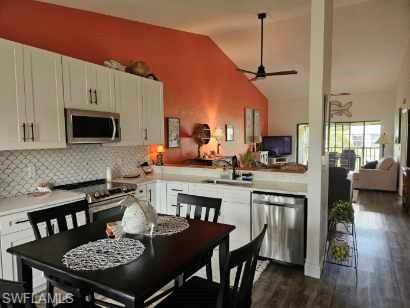 a kitchen with a dining table chairs and a stove