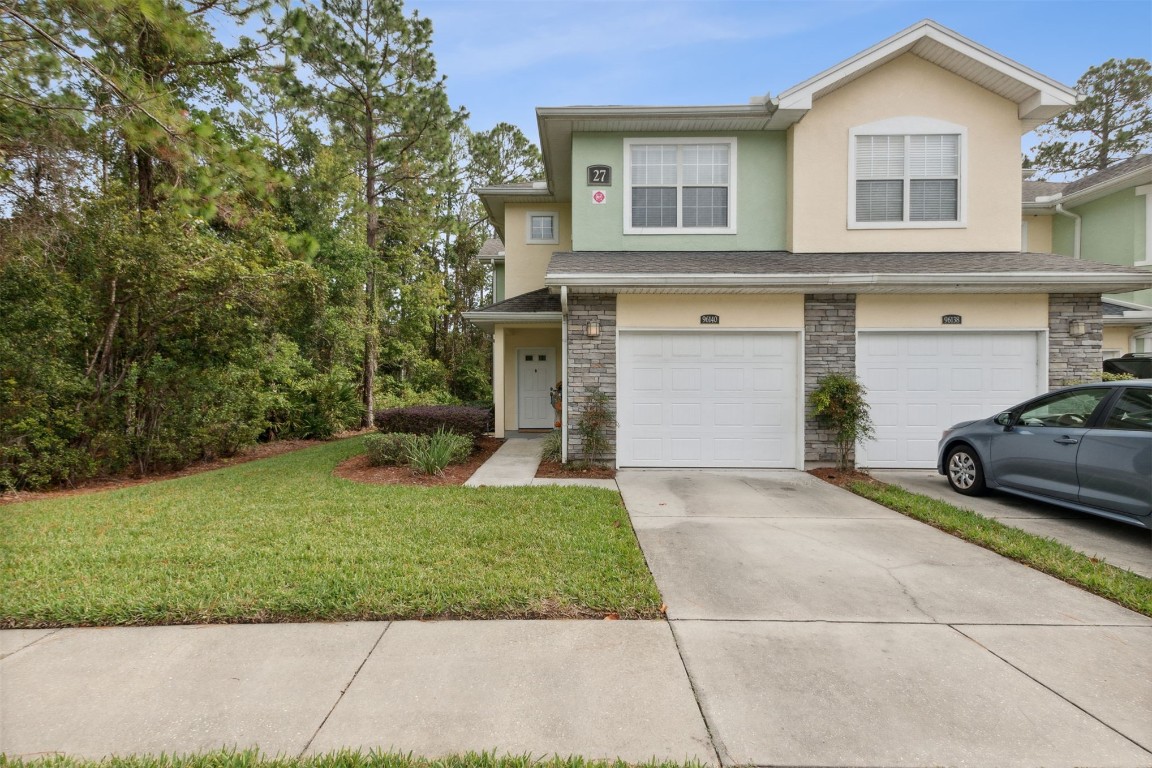 a front view of a house with a yard and garage