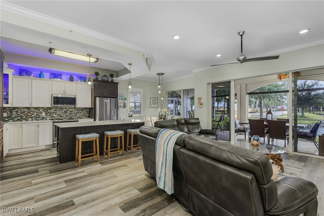 a living room with stainless steel appliances kitchen island granite countertop furniture and a kitchen view