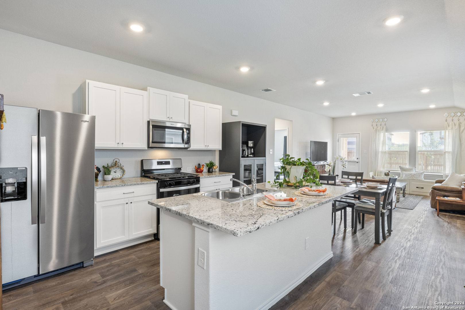 a kitchen with a sink a counter top stainless steel appliances and cabinets