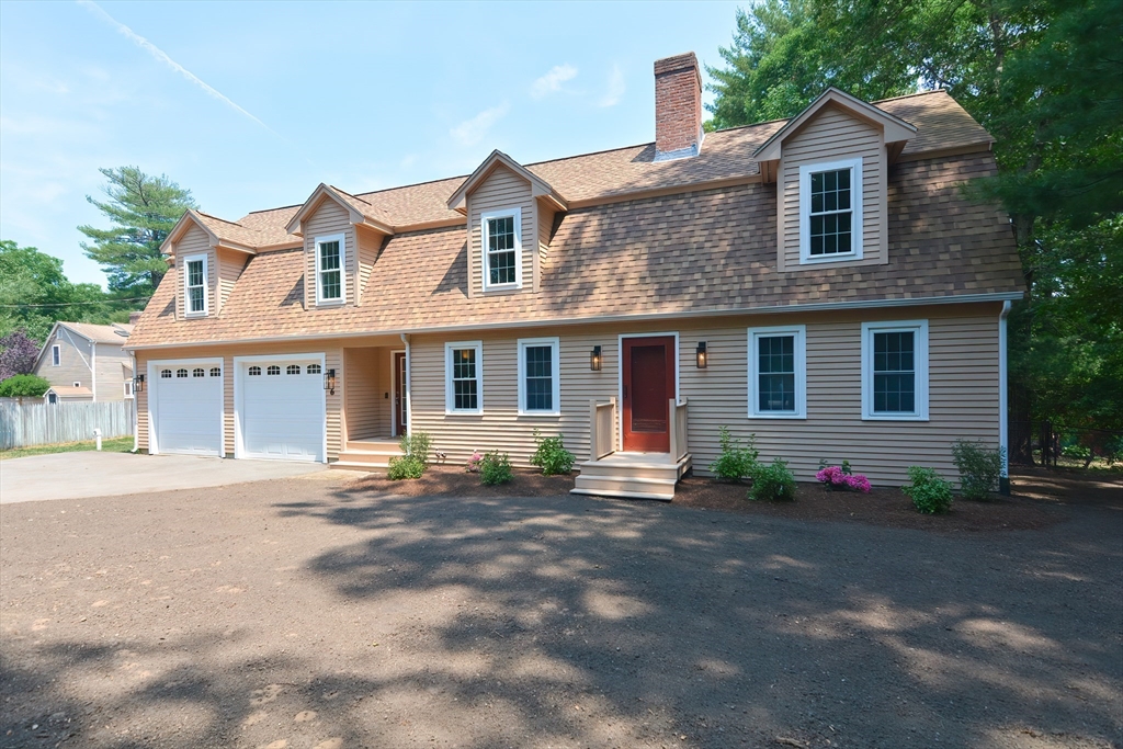 a front view of a house with a yard and a garage