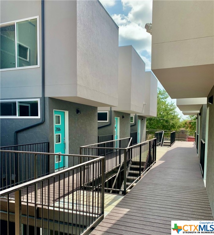 a view of a house with wooden deck