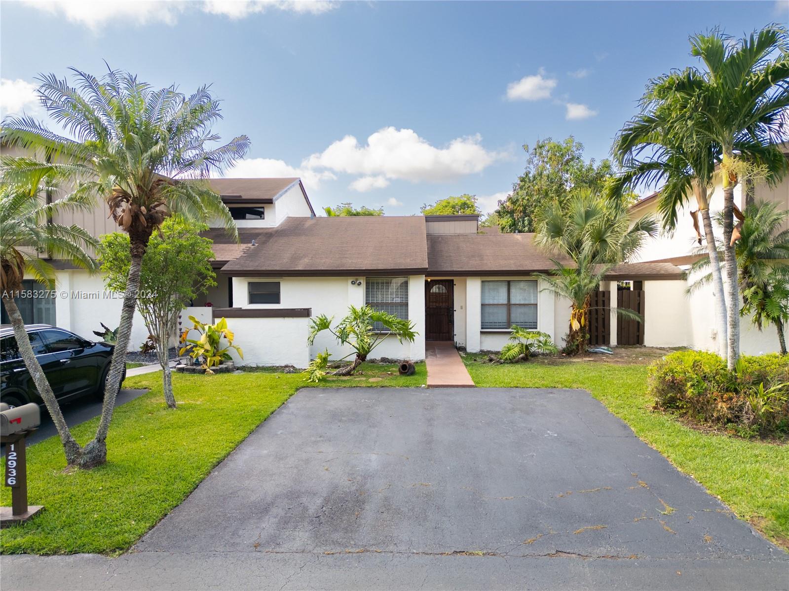 a front view of a house with garden and porch