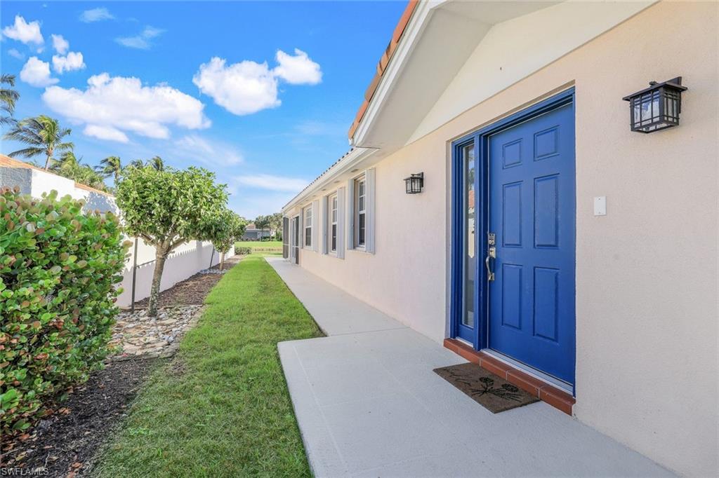 a view of an entrance to house with yard