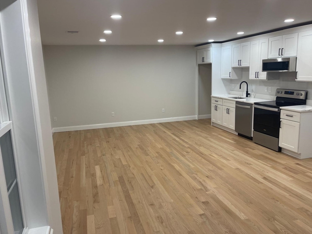 a view of kitchen with wooden floor