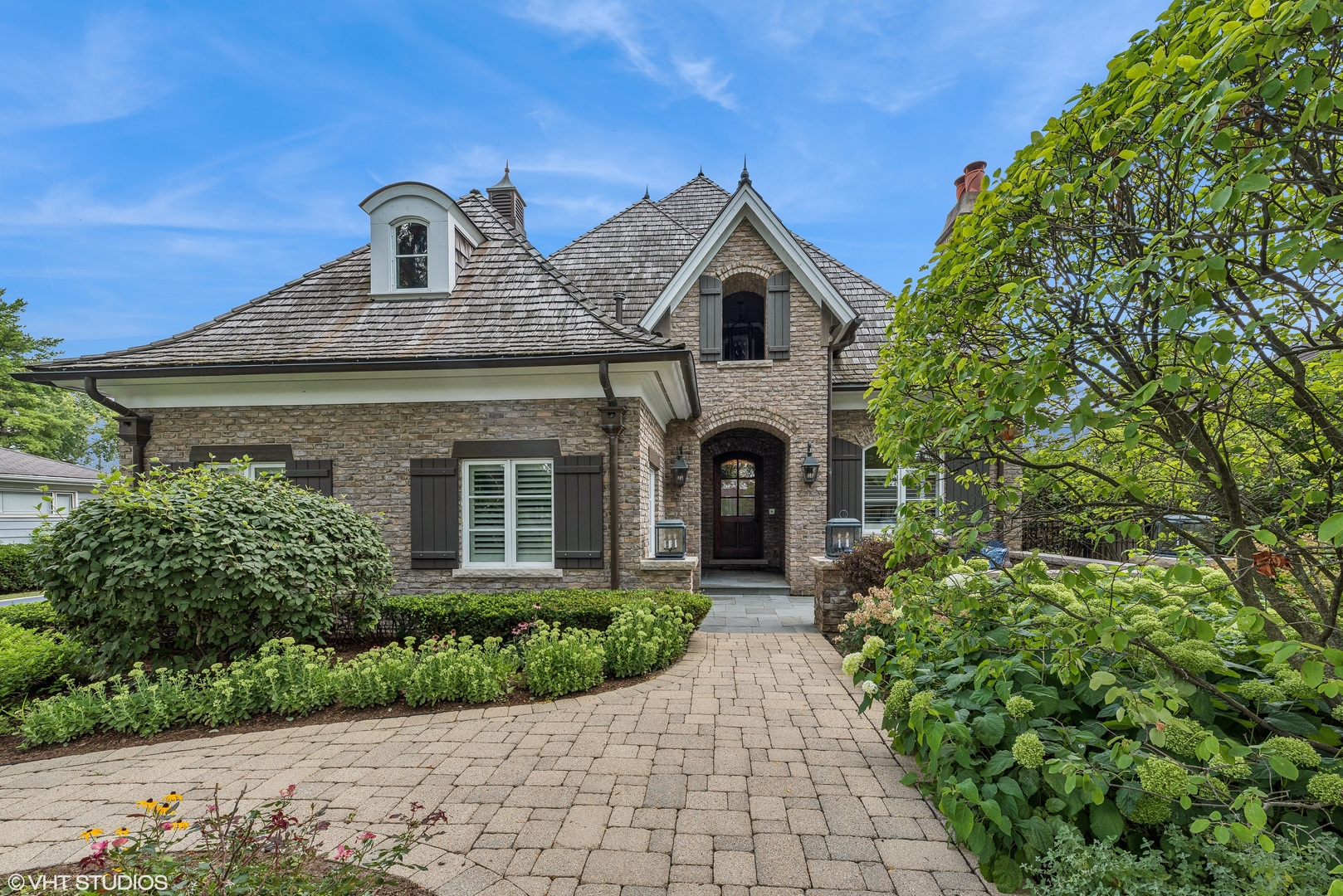 a front view of a house with garden