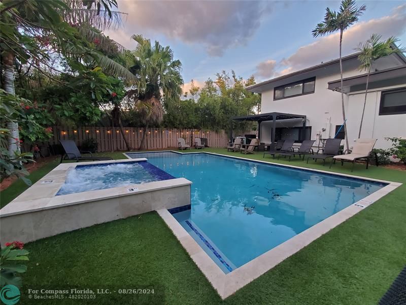 a view of a swimming pool with chairs