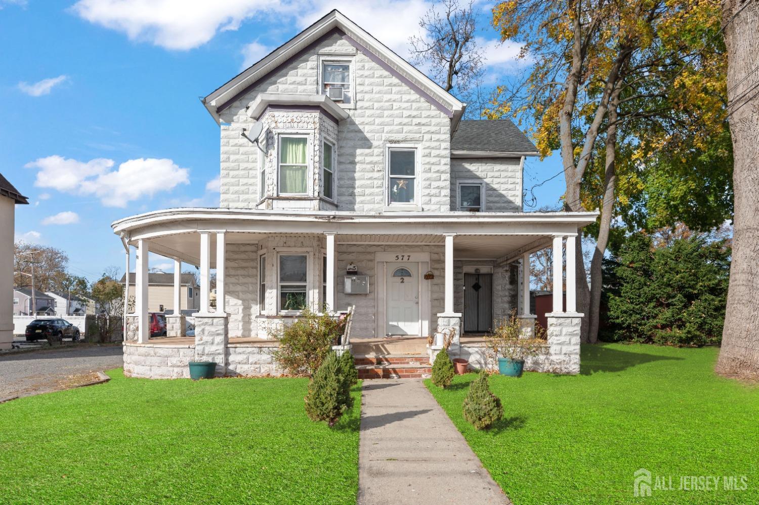 a front view of a house with a yard table and chairs