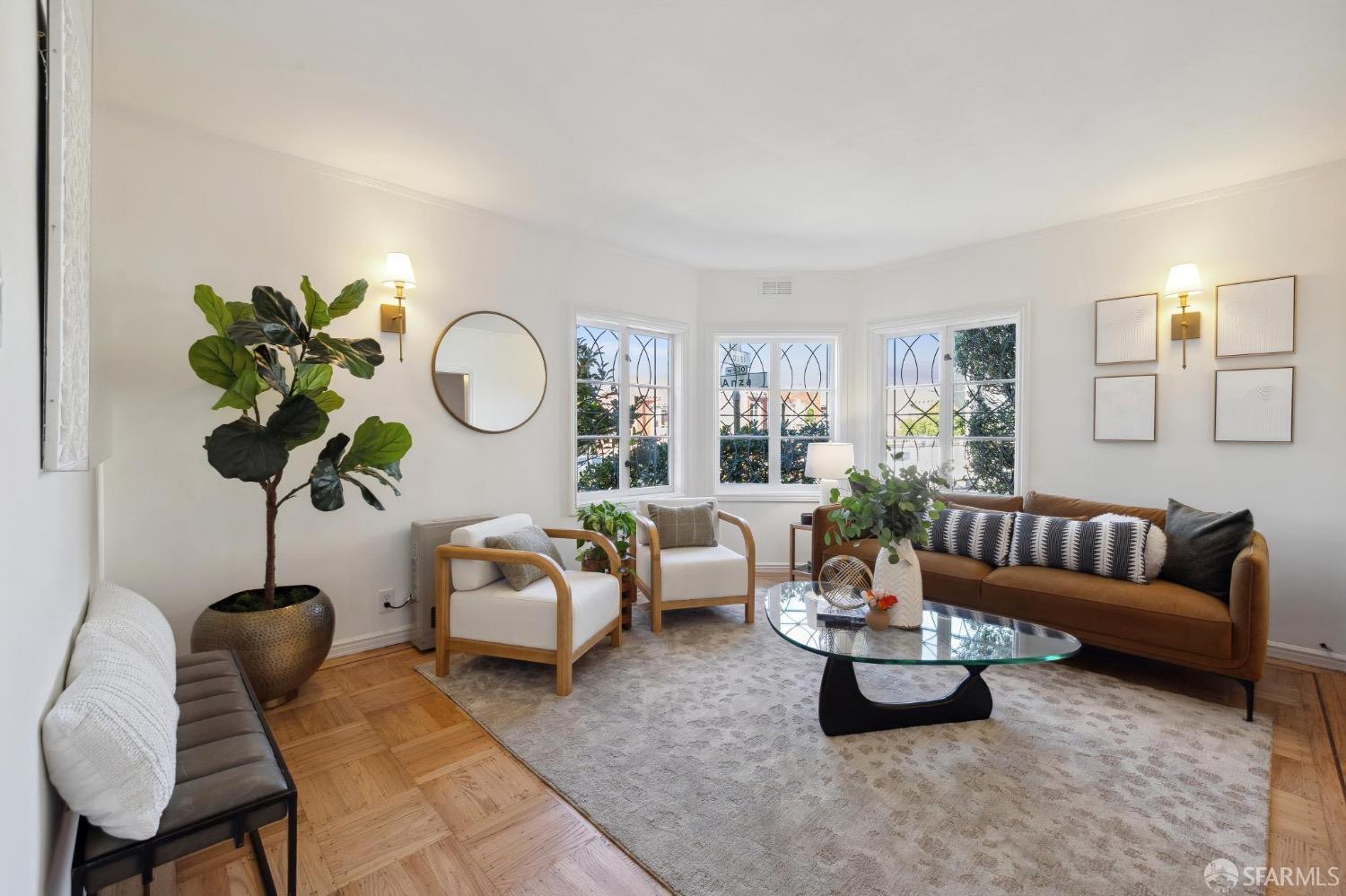 a living room with furniture and a potted plant