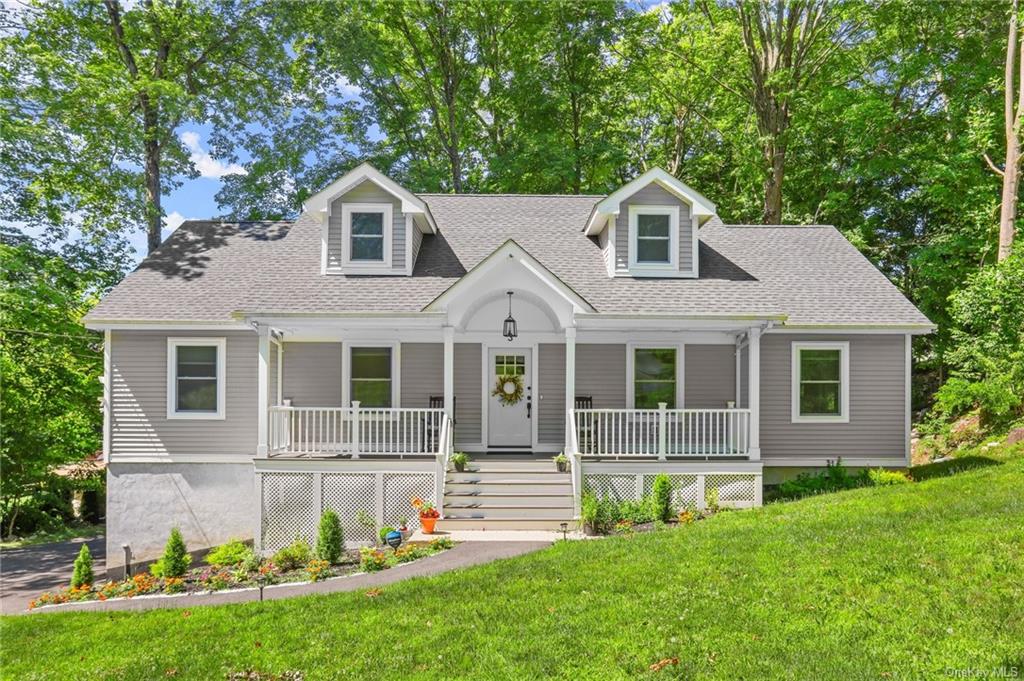 a front view of a house with a yard and porch